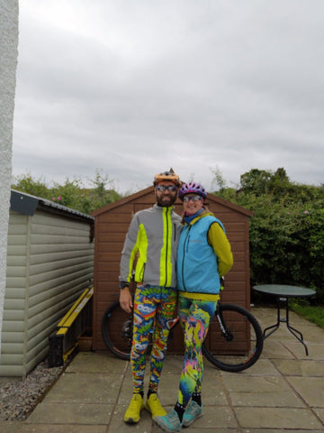 BTR cycling and running reflective high vis jacket on man standing next to lady