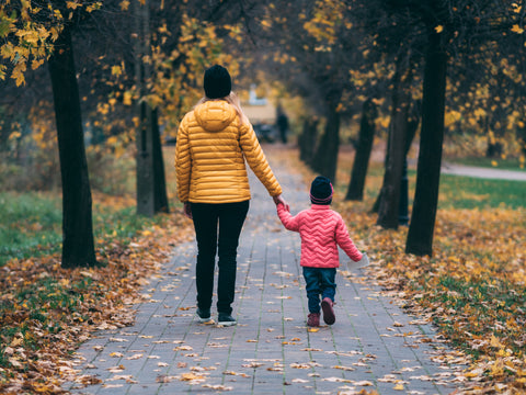 child holding hand with parent